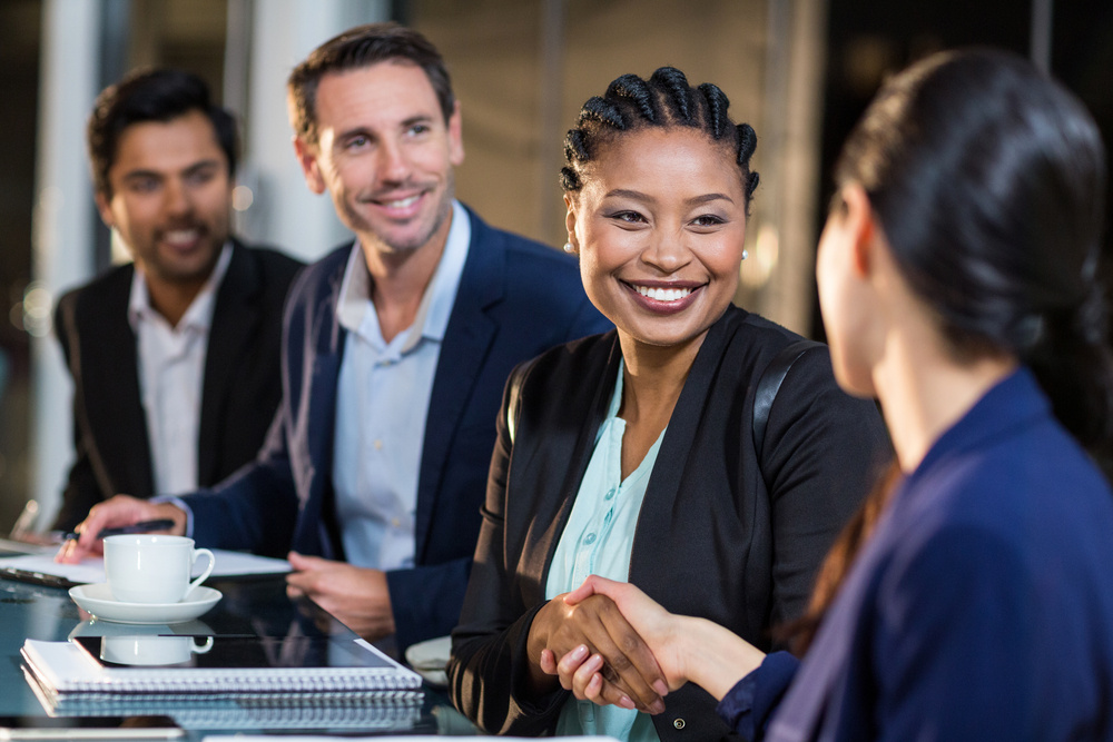 Businesswoman shaking hands with colleague in the office