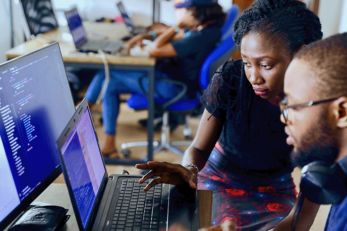 Two people looking at a computer 